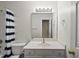 Clean bathroom featuring a vanity with a sink, a mirror with lighting, and a shower with a striped curtain at 116 Hidden Cellars Dr, Holly Springs, NC 27540