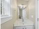 Bright bathroom featuring a vanity with a sink, a large mirror, and stylish lighting fixtures at 116 Hidden Cellars Dr, Holly Springs, NC 27540