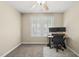 Bedroom with neutral walls and carpet, bright window, ceiling fan, and a desk set up for working at 116 Hidden Cellars Dr, Holly Springs, NC 27540