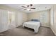 Cozy bedroom with a ceiling fan, neutral carpet, and a comfortable bed with blue pillows at 116 Hidden Cellars Dr, Holly Springs, NC 27540
