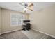 Bedroom with neutral walls and carpet, bright window, ceiling fan, and a desk set up for working at 116 Hidden Cellars Dr, Holly Springs, NC 27540