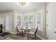 Charming breakfast nook with a round table, two chairs, and a bright bay window with plantation shutters at 116 Hidden Cellars Dr, Holly Springs, NC 27540
