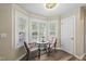 Charming breakfast nook with a round table, two chairs, and a bright bay window with plantation shutters at 116 Hidden Cellars Dr, Holly Springs, NC 27540