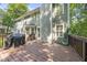 Wooden deck with dark brown stain, grill, open railing, and a view of the backyard trees at 116 Hidden Cellars Dr, Holly Springs, NC 27540