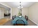Cozy dining room features natural lighting, carpeted floors, and a modern chandelier at 116 Hidden Cellars Dr, Holly Springs, NC 27540