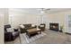 Comfortable living room featuring a fireplace, plush seating, and large windows at 116 Hidden Cellars Dr, Holly Springs, NC 27540
