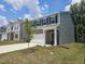 Charming home featuring a two-car garage, green grass, and manicured landscaping at 126 N Keatts Winner Ct, Wilson's Mills, NC 27520