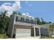 Two-story home featuring a gray exterior with brick accents and an attached two-car garage at 126 N Keatts Winner Ct, Wilson's Mills, NC 27520