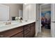Bathroom boasting a double sink vanity, a large mirror and a decorative floral piece atop the counter at 149 Hadley Ln, Clayton, NC 27527