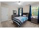 Bedroom featuring neutral walls, carpet, and furniture with a blue and gray color scheme at 149 Hadley Ln, Clayton, NC 27527