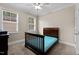 Bedroom showcasing large windows, neutral walls, ceiling fan, and plush carpet at 149 Hadley Ln, Clayton, NC 27527