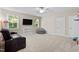 Spacious bonus room featuring a comfortable sofa, large windows, and ample space for relaxation and entertainment at 149 Hadley Ln, Clayton, NC 27527