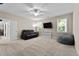 Inviting bonus room with a TV, sofa, and beanbag chair, creating a cozy and versatile living space at 149 Hadley Ln, Clayton, NC 27527