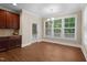 Bright breakfast nook features large windows, a door to the outside, and wood-look floors at 149 Hadley Ln, Clayton, NC 27527