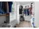 A walk in closet with clothes and storage on multiple levels and a window for natural light at 149 Hadley Ln, Clayton, NC 27527