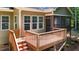 Wooden deck with stairs in backyard and adjacent screened porch at 149 Hadley Ln, Clayton, NC 27527