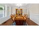 Formal dining room featuring a wooden table with chairs, a hutch, and large windows at 149 Hadley Ln, Clayton, NC 27527