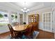 Formal dining room featuring a wooden table with chairs, a hutch, and large windows at 149 Hadley Ln, Clayton, NC 27527