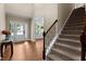 Inviting entryway with staircase featuring carpeted steps and wrought iron spindles at 149 Hadley Ln, Clayton, NC 27527