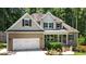 Charming two-story home featuring a welcoming front porch, lush landscaping, and a convenient attached two-car garage at 149 Hadley Ln, Clayton, NC 27527