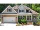 Charming two-story home with neutral-colored siding, well-manicured landscaping, and an attached two-car garage at 149 Hadley Ln, Clayton, NC 27527
