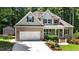 Charming two-story home with neutral-colored siding, well-manicured landscaping, and an attached two-car garage at 149 Hadley Ln, Clayton, NC 27527