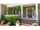 Inviting front porch with decorative plants, brick steps, and a classic front door with glass panels at 149 Hadley Ln, Clayton, NC 27527