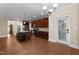 Open concept kitchen features dark wood cabinets, granite countertops, an island with seating and stainless steel appliances at 149 Hadley Ln, Clayton, NC 27527