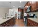 Spacious kitchen with granite countertops, a center island, stainless steel appliances, and dark wood cabinets at 149 Hadley Ln, Clayton, NC 27527