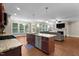 Open-concept kitchen with a center island and view into the living room, with ample natural light at 149 Hadley Ln, Clayton, NC 27527