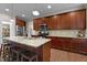 Spacious kitchen with granite countertops, a center island, stainless steel appliances, and dark wood cabinets at 149 Hadley Ln, Clayton, NC 27527