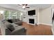 This living room features a fireplace, built-in shelving, and large windows with backyard views at 149 Hadley Ln, Clayton, NC 27527