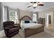Comfortable main bedroom showcases a decorative bed, ceiling fan, and ample natural light at 149 Hadley Ln, Clayton, NC 27527