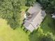 An aerial view of a charming home with a lush lawn, mature trees, and a welcoming driveway at 150 Williamston Ridge Dr, Youngsville, NC 27596
