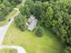 Aerial view of home surrounded by mature trees, and a well-manicured lawn in quiet neighborhood at 150 Williamston Ridge Dr, Youngsville, NC 27596