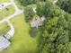 Aerial view of home surrounded by mature trees, and a well-manicured lawn at 150 Williamston Ridge Dr, Youngsville, NC 27596