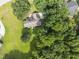 Expansive aerial view of a charming home surrounded by lush greenery and a well-manicured lawn at 150 Williamston Ridge Dr, Youngsville, NC 27596