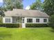 Spacious backyard features a screened porch with a small stairway and manicured shrubs at 150 Williamston Ridge Dr, Youngsville, NC 27596
