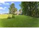 Large, well-maintained backyard with lush green lawn and mature trees, perfect for outdoor activities at 150 Williamston Ridge Dr, Youngsville, NC 27596