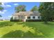 The backyard has mature trees and a screened-in porch at 150 Williamston Ridge Dr, Youngsville, NC 27596