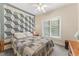 Cozy bedroom featuring a quilted bedspread, accent wall hanging and natural light from the window at 150 Williamston Ridge Dr, Youngsville, NC 27596