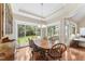 Bright dining room with wood table, matching chairs and large windows with a view of the backyard at 150 Williamston Ridge Dr, Youngsville, NC 27596