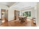 Well-lit dining room featuring hardwood floors, large window, and classic wooden furniture at 150 Williamston Ridge Dr, Youngsville, NC 27596