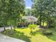 Beautiful single story brick home with mature trees, green grass, and well-maintained landscaping at 150 Williamston Ridge Dr, Youngsville, NC 27596