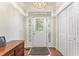 Welcoming foyer showcasing an ornate glass front door, hardwood floors, and a storage closet at 150 Williamston Ridge Dr, Youngsville, NC 27596