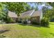 Charming brick home featuring a welcoming front porch, manicured landscaping, and a well-maintained lawn at 150 Williamston Ridge Dr, Youngsville, NC 27596