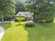 Charming home with a well-manicured lawn and lush landscaping creating a serene setting at 150 Williamston Ridge Dr, Youngsville, NC 27596