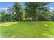 Beautiful front yard with mature trees and lush landscaping at 150 Williamston Ridge Dr, Youngsville, NC 27596