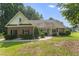 Charming brick home with a manicured lawn, lush landscaping, and a welcoming front porch at 150 Williamston Ridge Dr, Youngsville, NC 27596