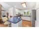 Bright kitchen with blue countertops, stainless steel appliances, and hardwood floors at 150 Williamston Ridge Dr, Youngsville, NC 27596